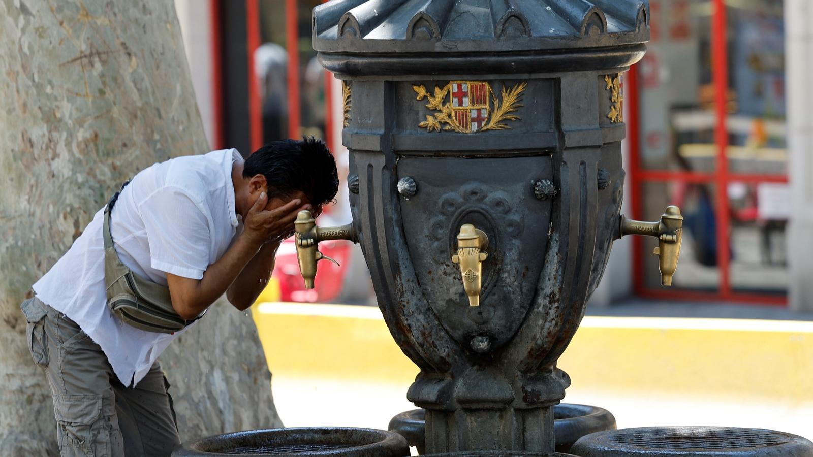 A tourist cooling off at the Canaletes fountain, during a heatwave