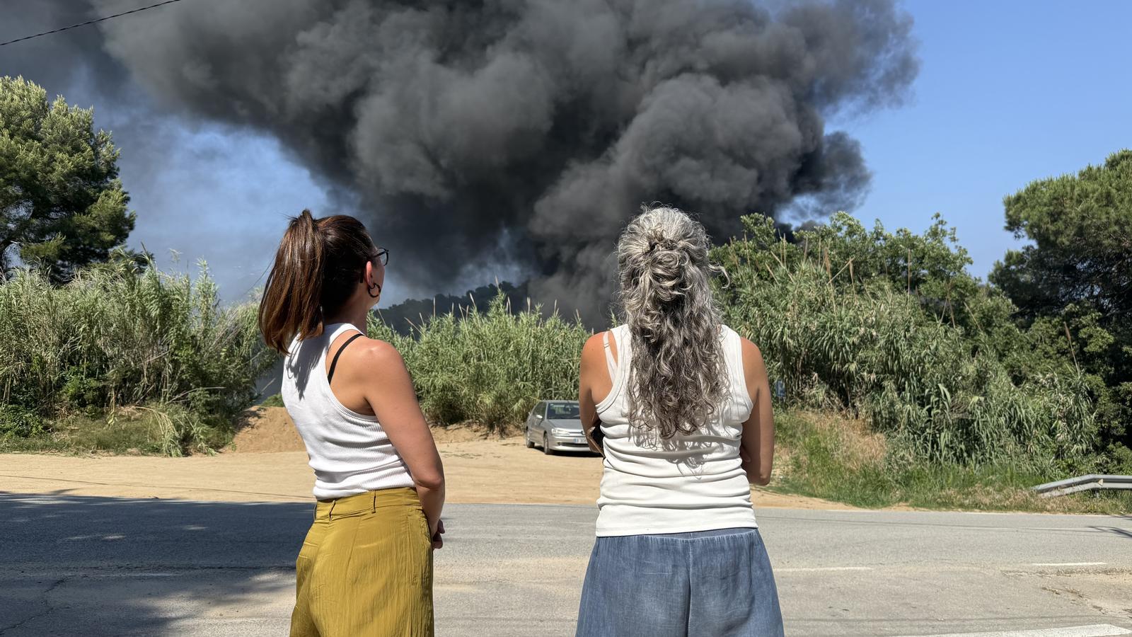 Two of the evicted neighbors observing the column of smoke.