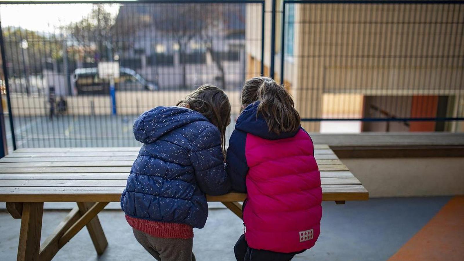 Two girls playing in the courtyard of a school in Barcelona.