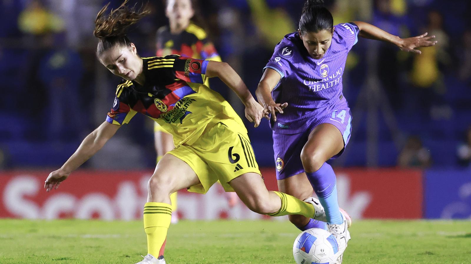 Bruna Vilamala (left), from Club América, fights for a ball with Viviana Villacorta, from Orlando Pride, during a Concacaf Champions Cup match in Mexico City.