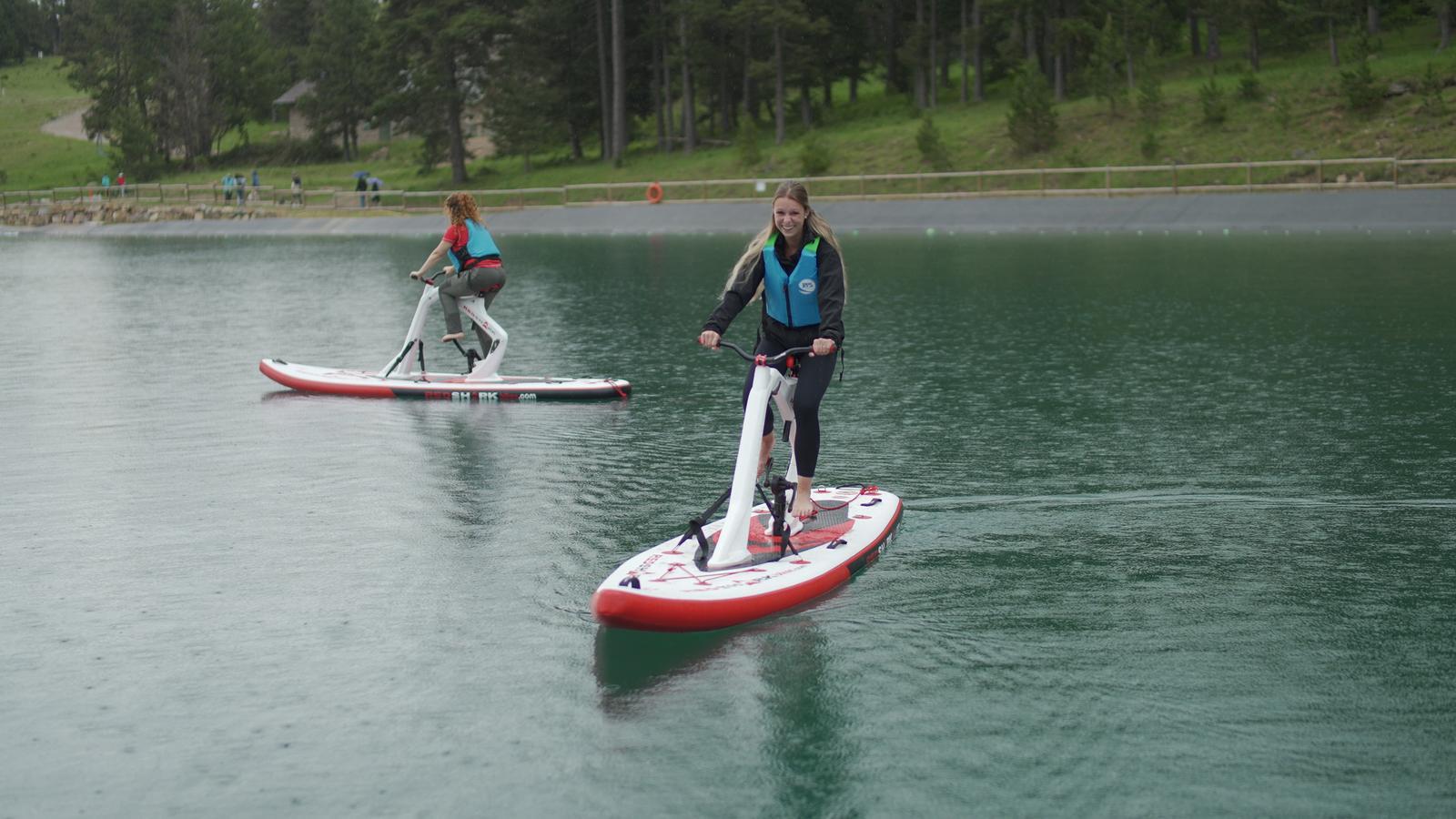 Visitors practicing water cycling on La Molina Lake.