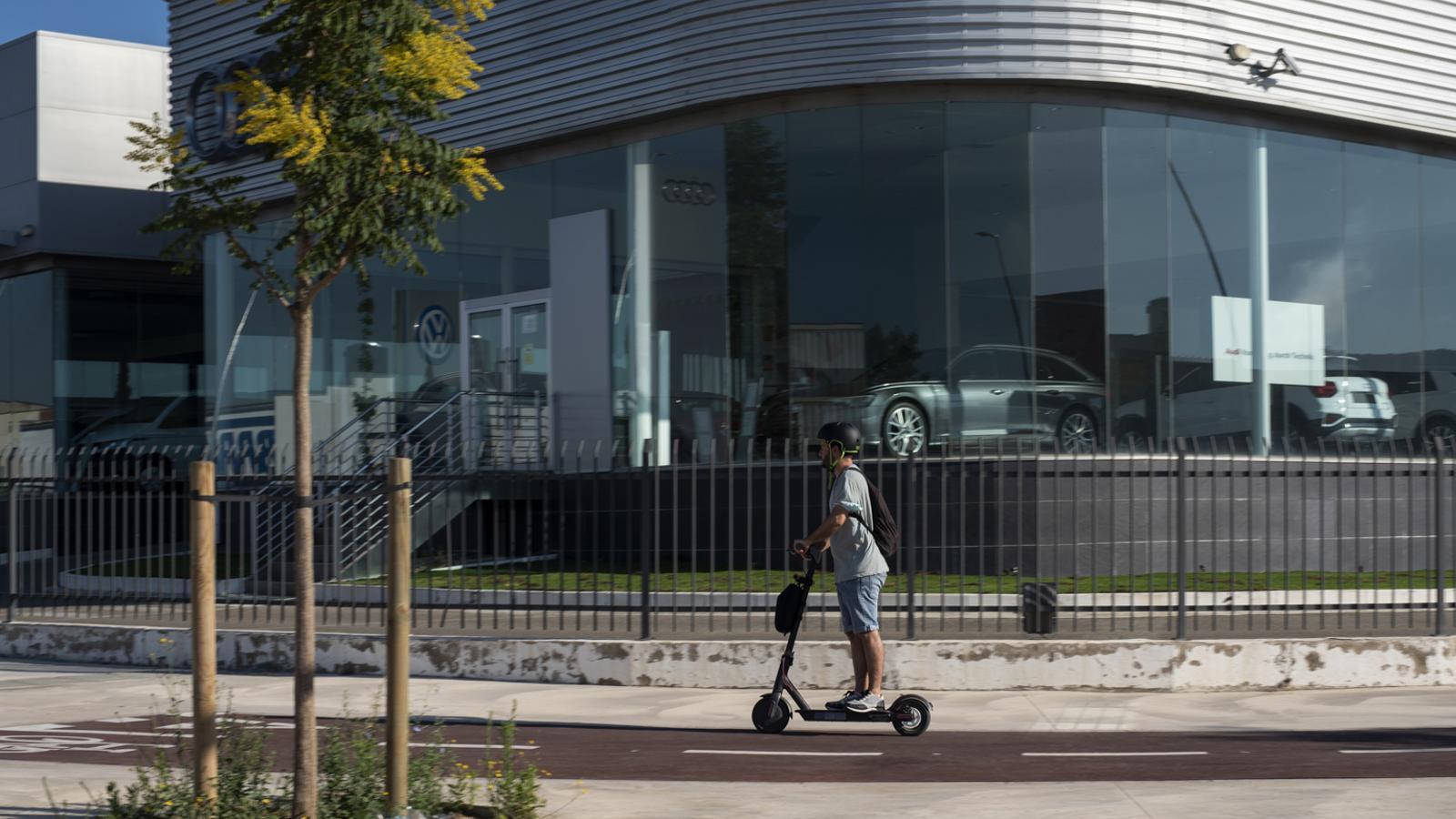 A boy riding an electric scooter in the Les Comes industrial estate in Igualada.