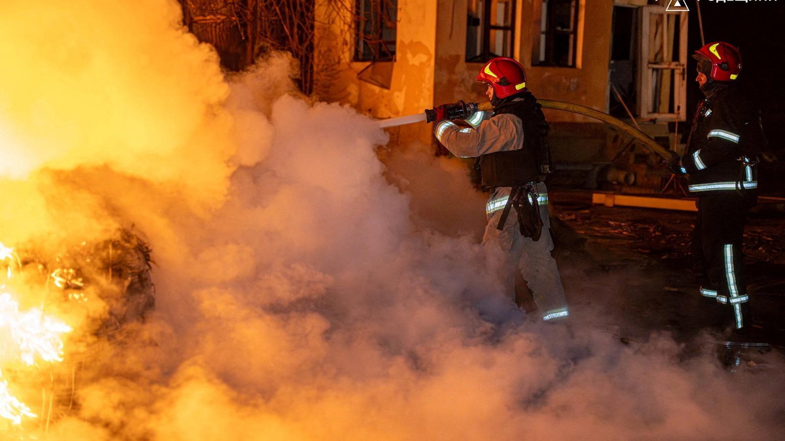 Firefighters extinguish a fire caused by a Russian attack in Odesa, Ukraine, on Saturday night.