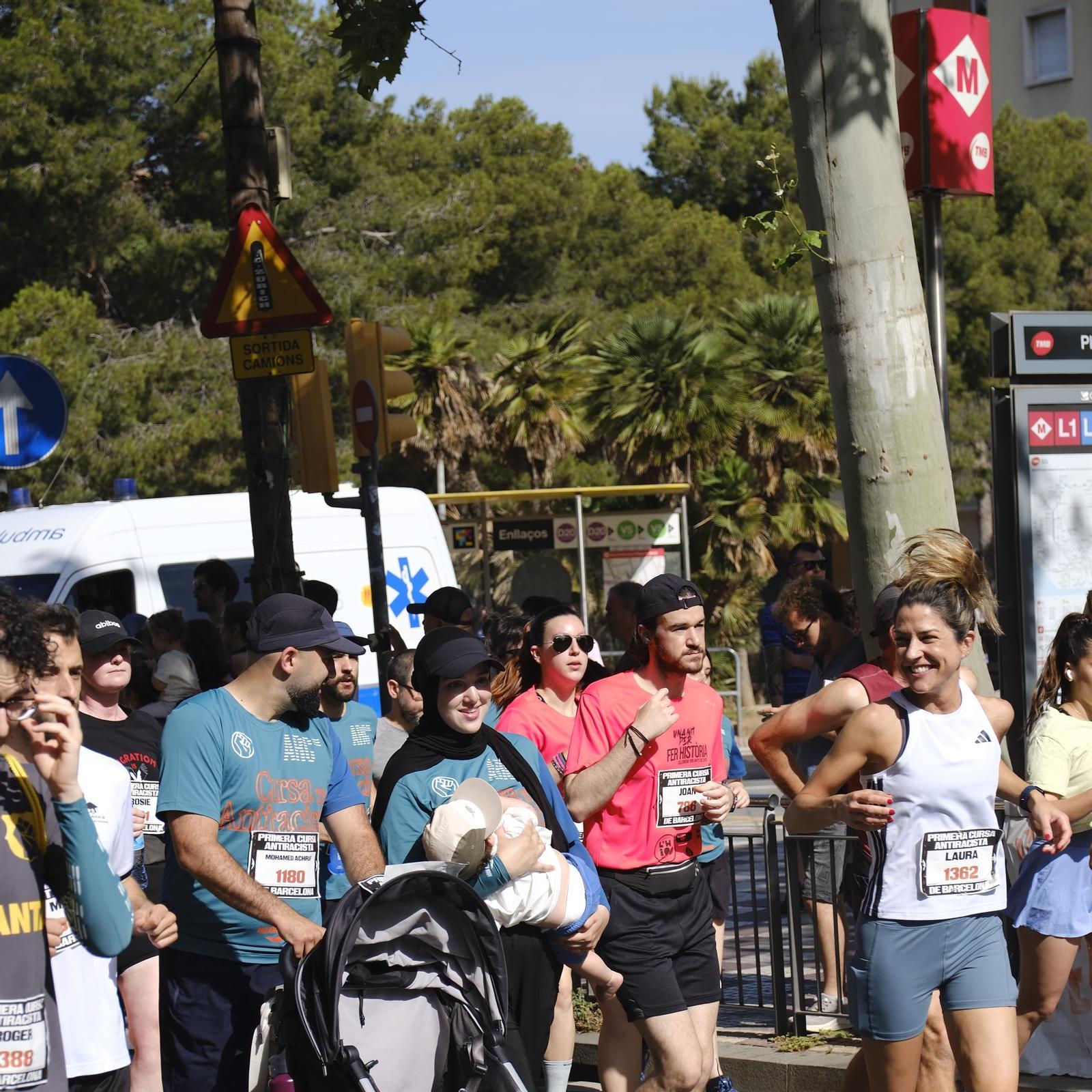 A woman breastfeeding her baby at a race.