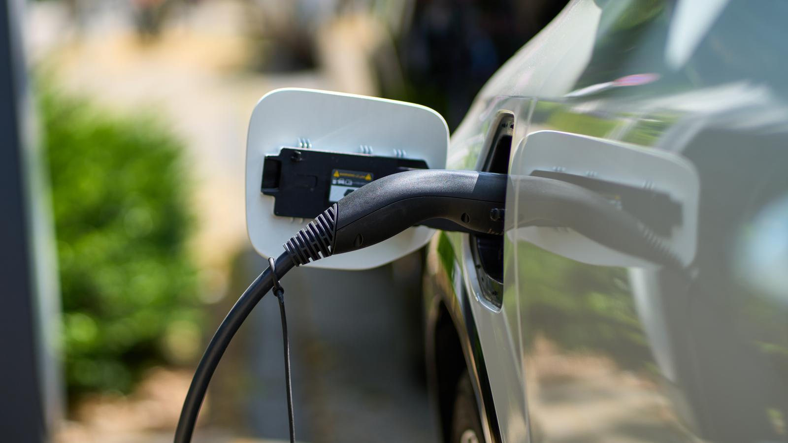 An electric car charging in a stock image.