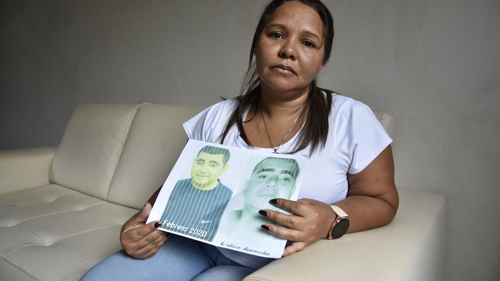 Eglis Manaure shows a portrait of her husband, Enrique Parada, who remains in Venezuelan prison despite suffering from pancreatic cancer