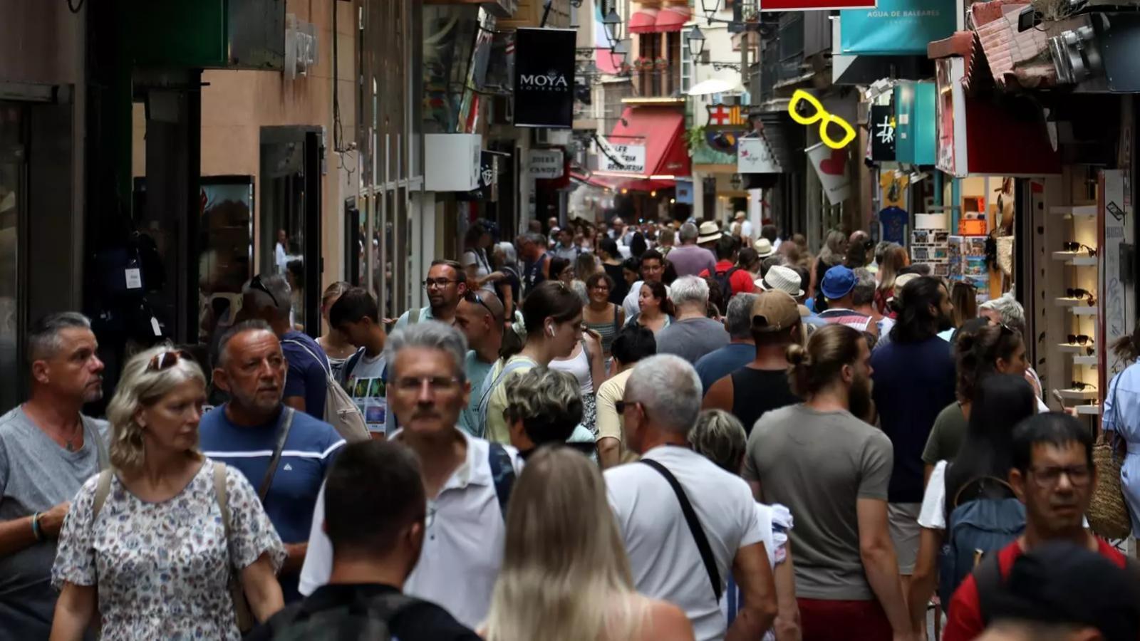 Tourists in a street in the center of Palma.