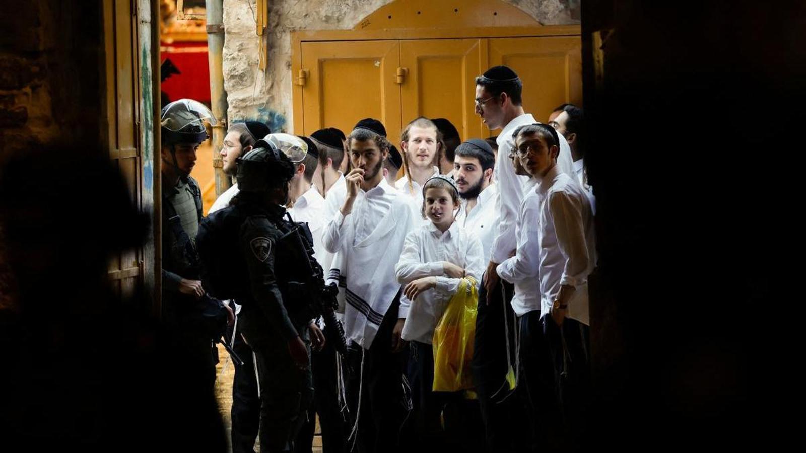 Israeli soldiers keep watch during a rally of Israeli settlers in Hebron, in the Israeli-occupied West Bank.
