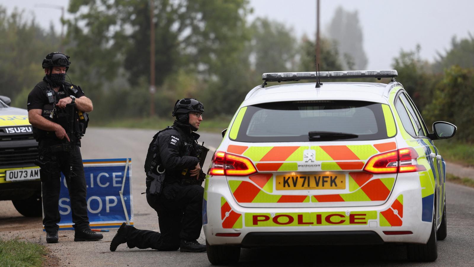 Police agents watch the area while road controls are maintained near the RAF Fairford air base.
