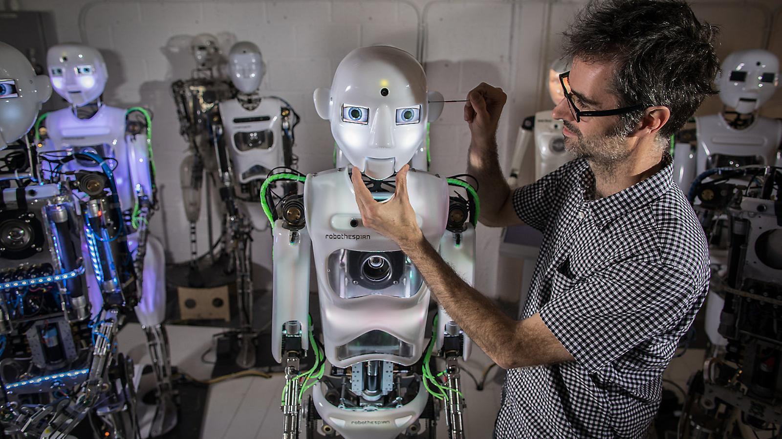 An engineer from Engineered Artes with a Robo Thespian robot, one of the company's interactive, multilingual models.