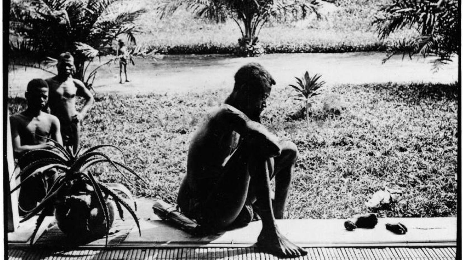 Nsala observing her five-year-old daughter's feet and hands