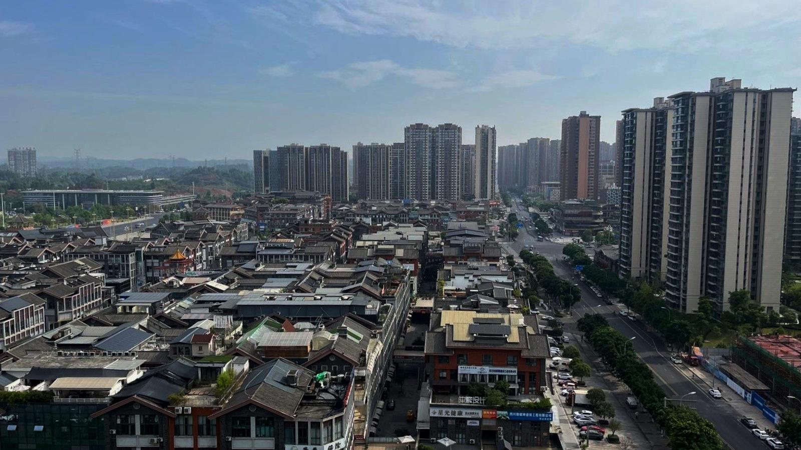 The center of the Chinese city of Leshan, where dozens of tall buildings contrast with traditional houses.