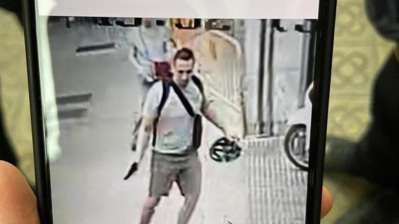 The author of the crime, with the gun in his hand, next to the victim.