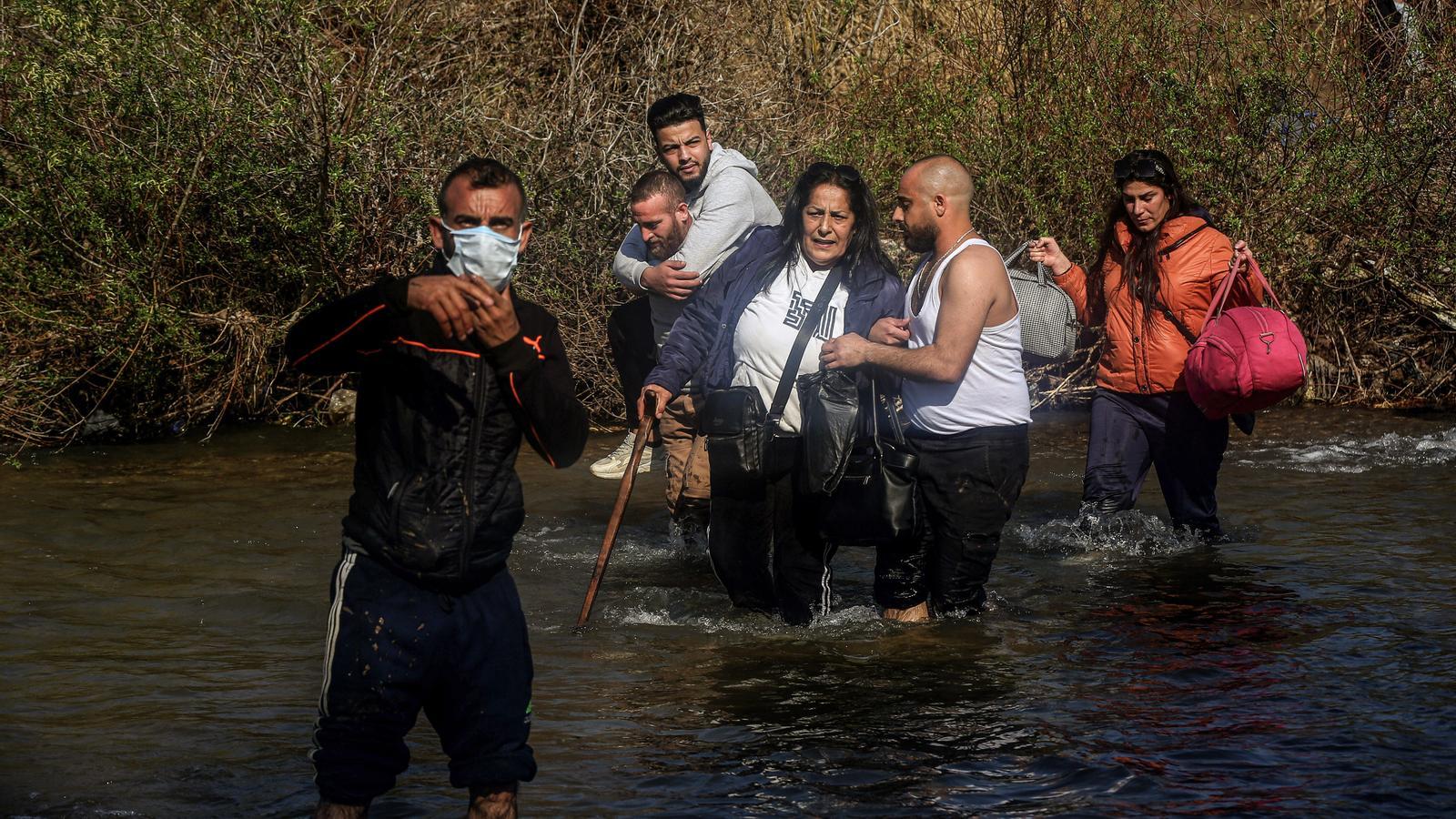 Alawite refugees cross the al-Nahr al-Kabir River toward the Lebanese village of Hekr El Dahri, fleeing the violence in Latakia and Tartus. File photo.