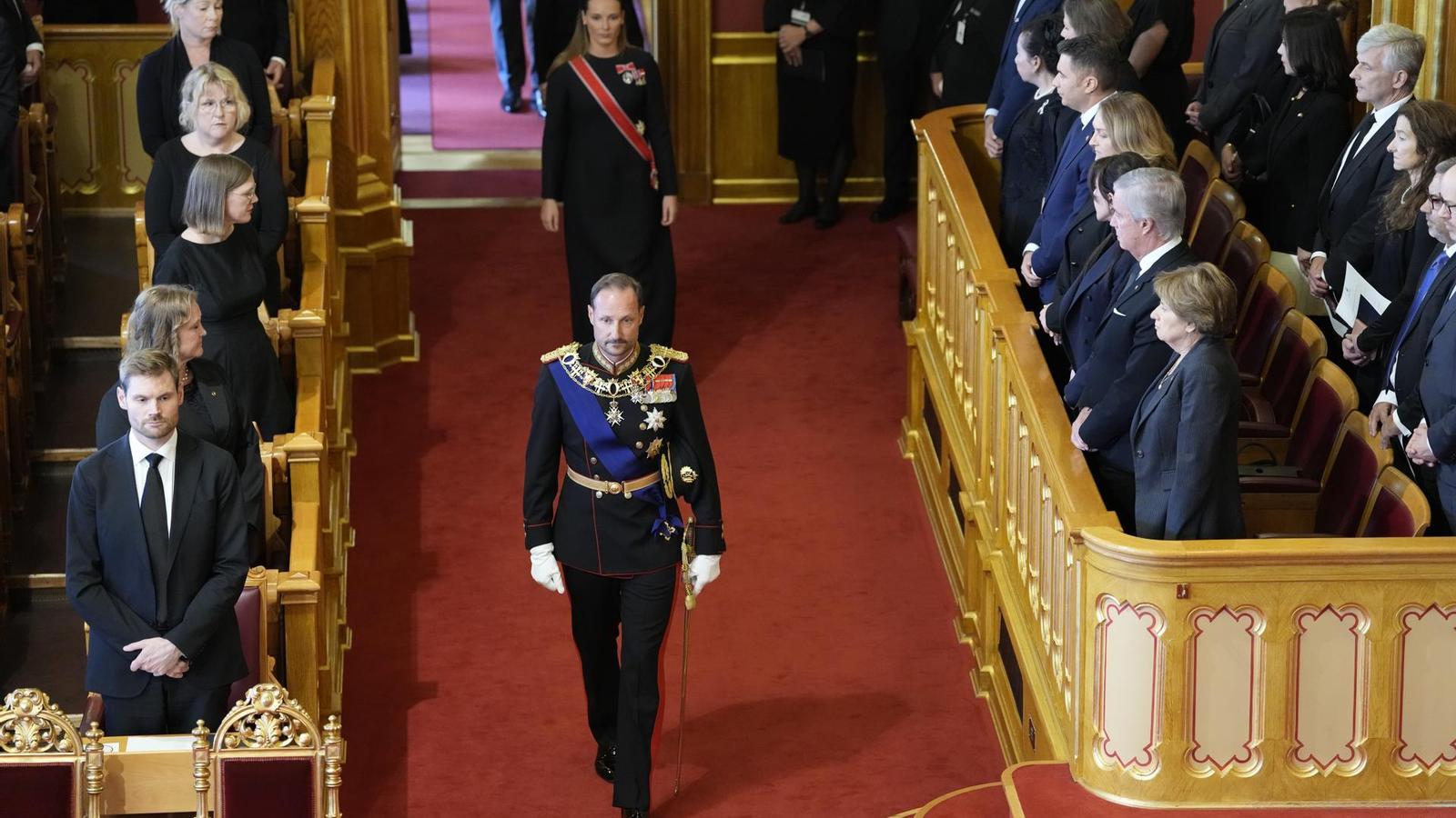 King Haakon VIII of Norway enters the parliament to swear the Constitution.
