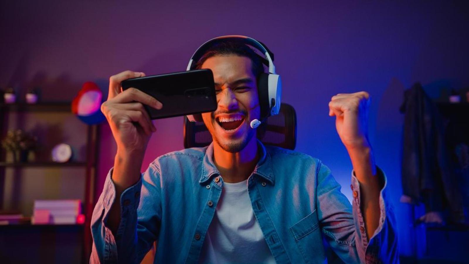 Boy plays through the mobile a video game.