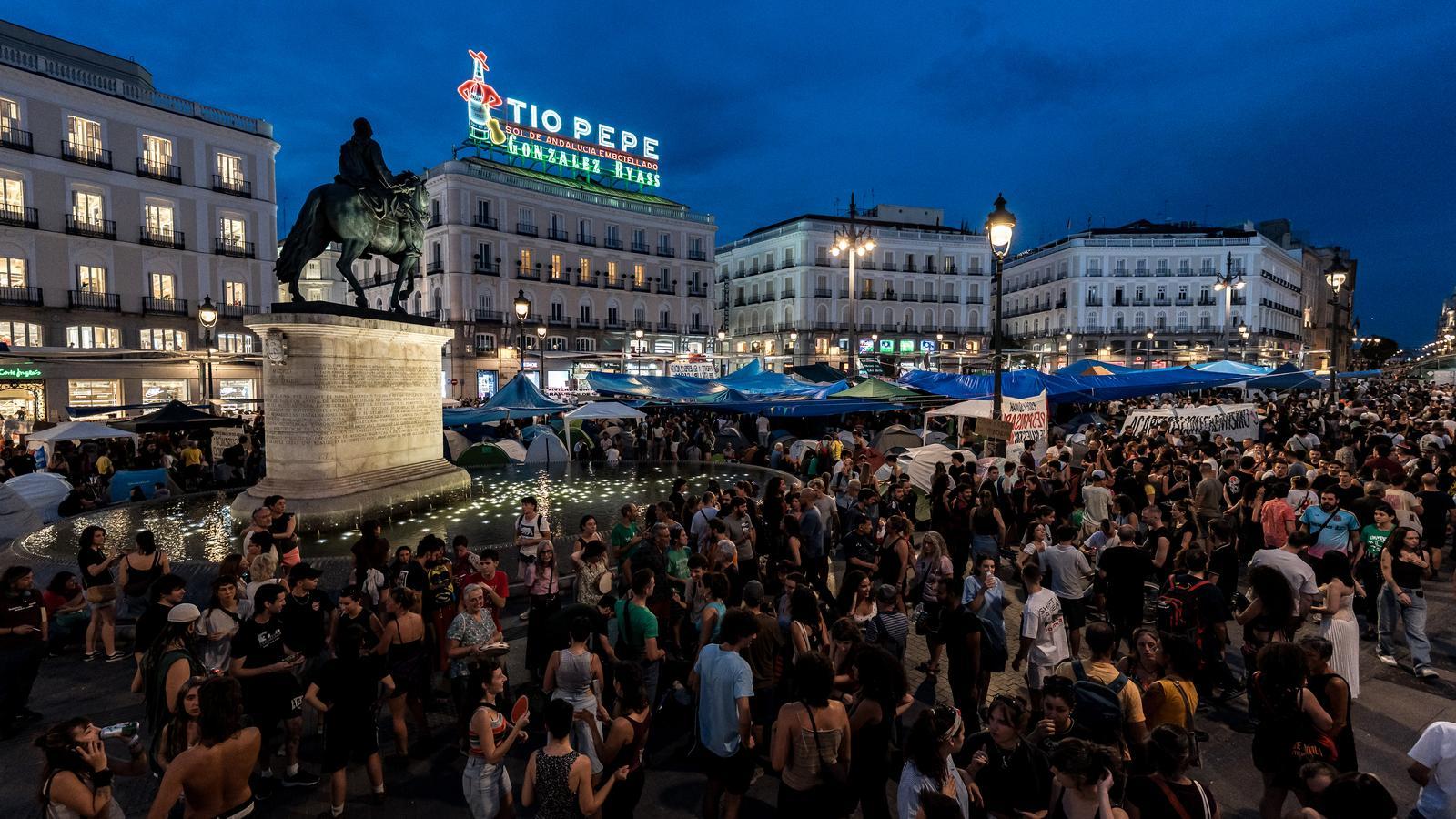 Thousands of people spend the second night camped in the Plaza del Sol in Madrid.