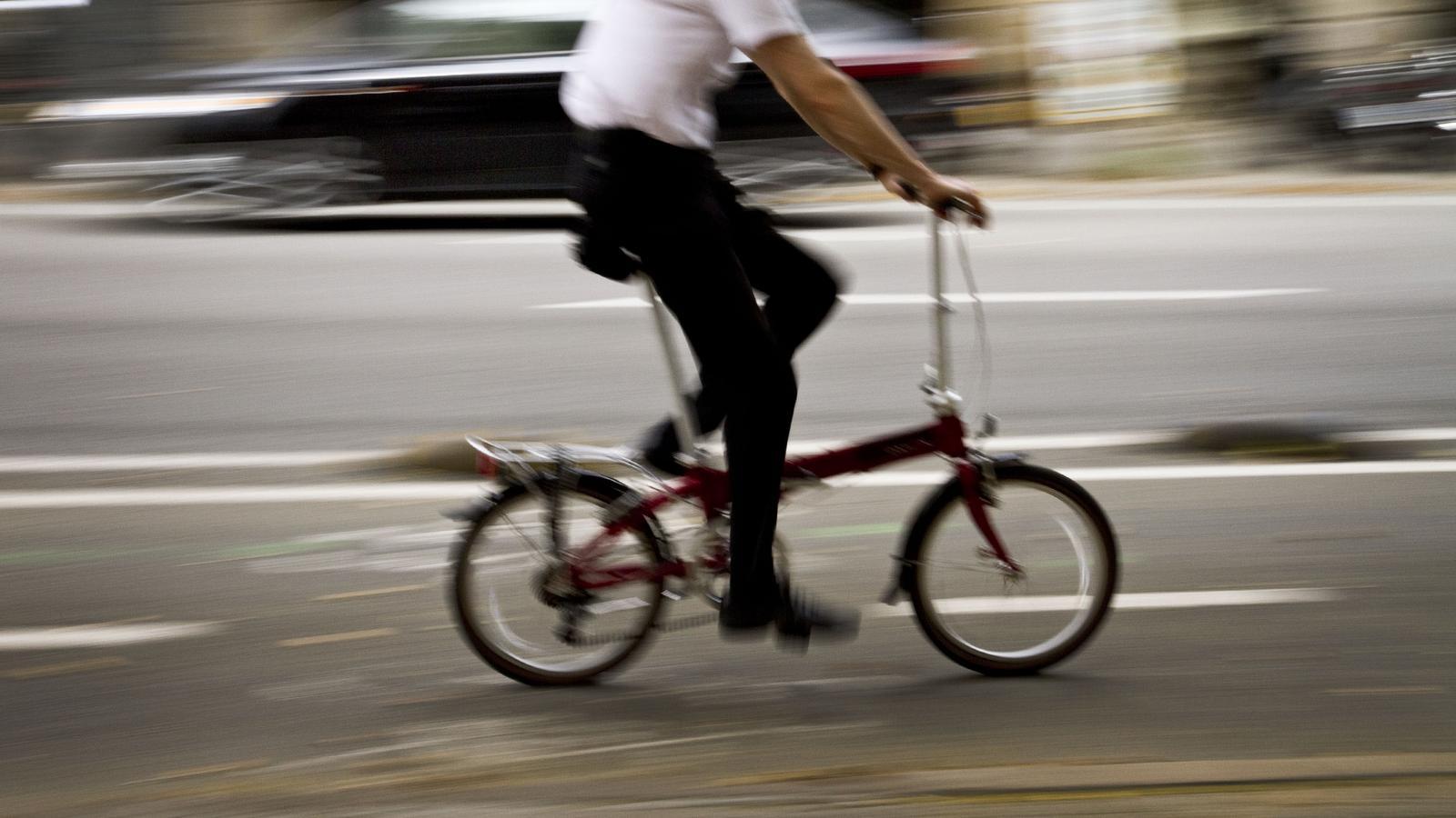 A cyclist riding along a bike lane in Barcelona.