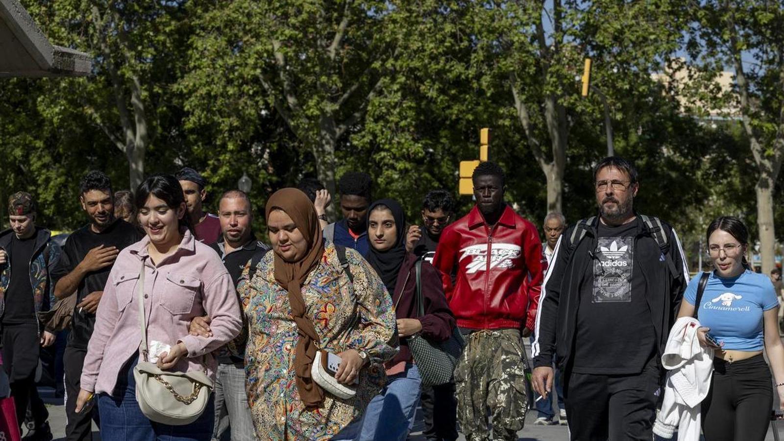 A group of people of diverse nationalities crossing a street in Barcelona