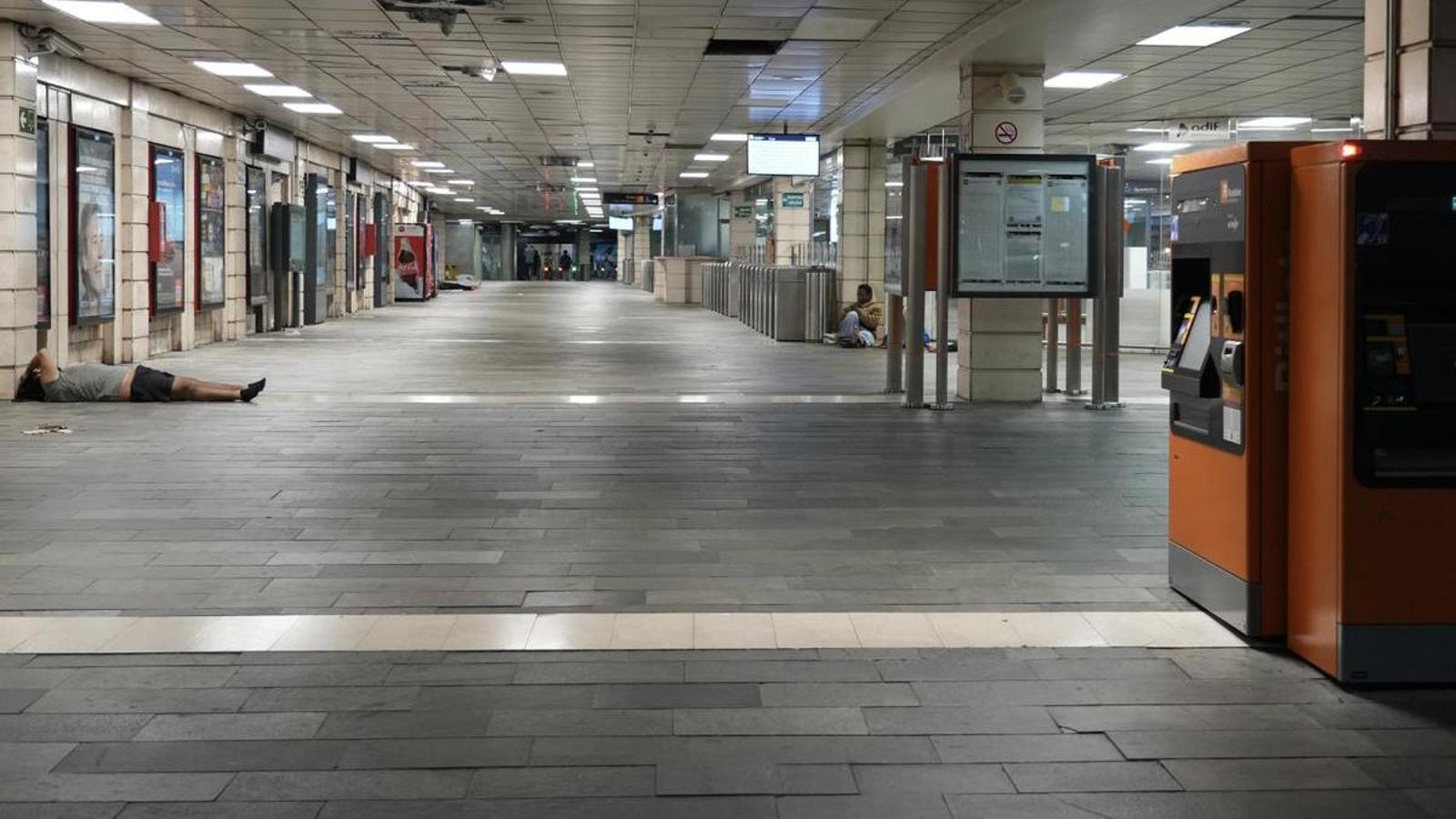 The Plaça Catalunya commuter train station, practically empty and with people waiting