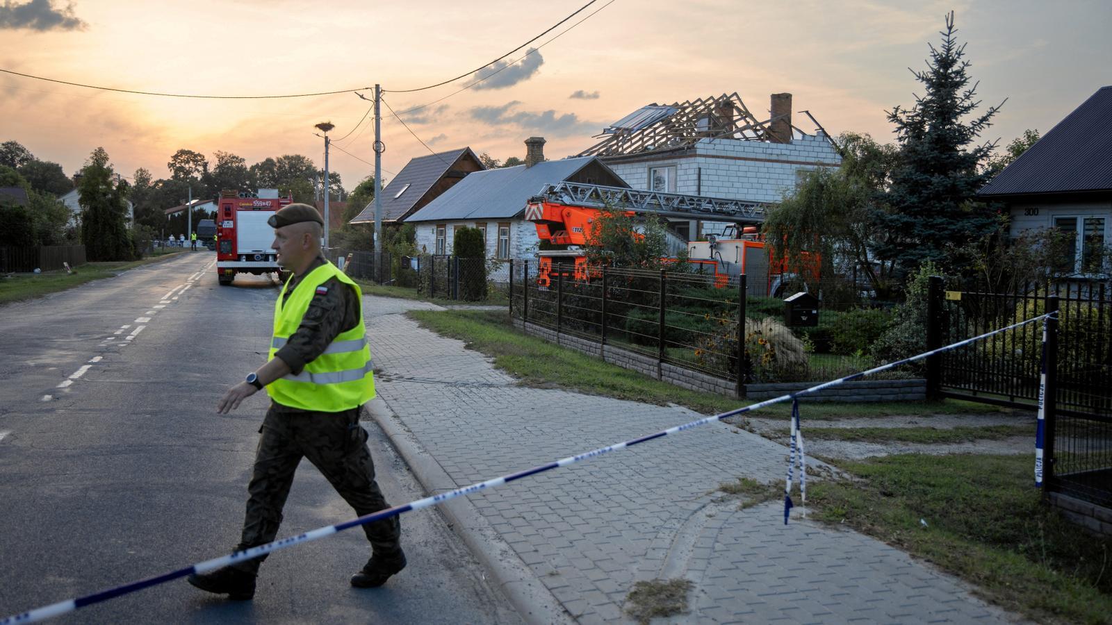 A soldier walks near a house damaged by a fragment of a suspected Russian drone shot down after intrusion into Polish airspace, in the municipality of Wyryki.