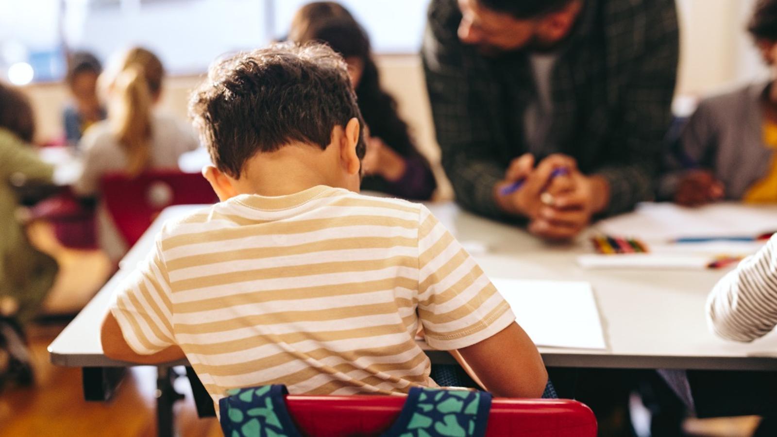 A student in a classroom, in an archive image
