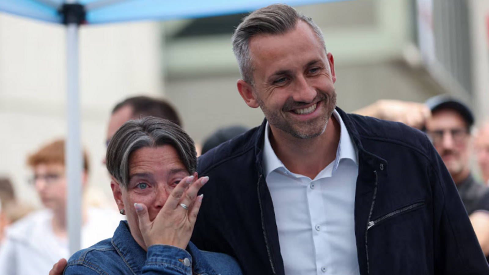 Ulrich Siegmund poses for a photograph with a visibly excited supporter, while campaigning in Dessau.