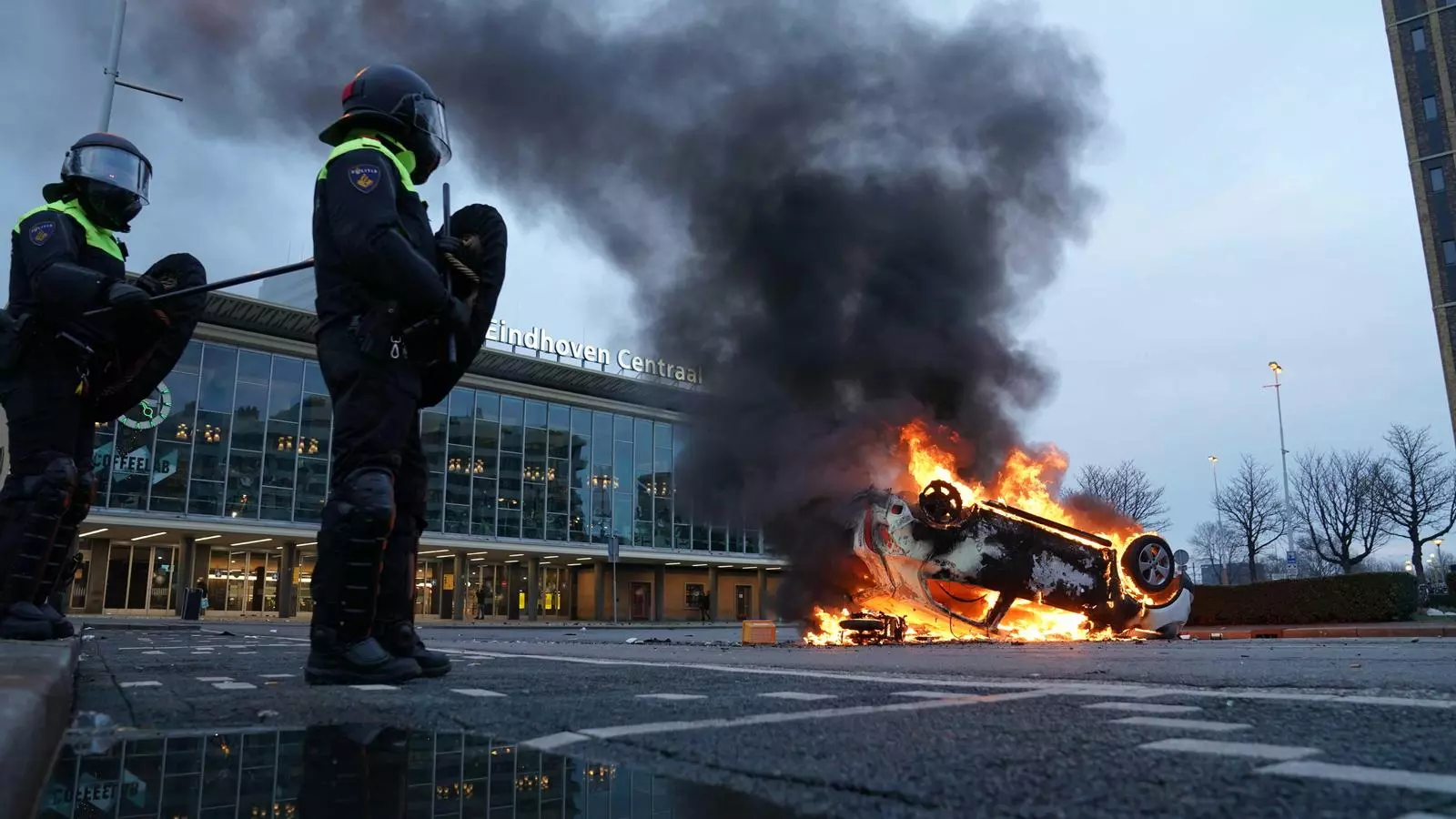Los manifestantes queman un coche ante la estación de Eindhoven
