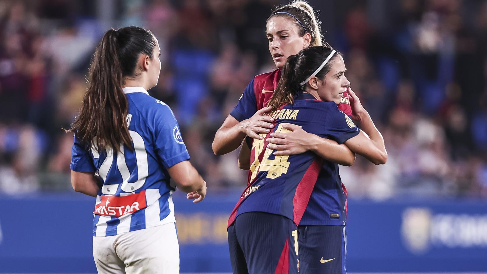 Aitana Bonmatí and Alexia Putellas hug each other during a match last season against Espanyol.