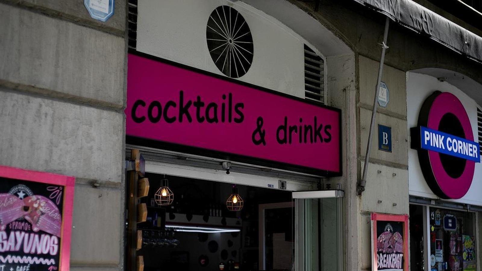 A sign for a bar in downtown Barcelona, labeled in English.
