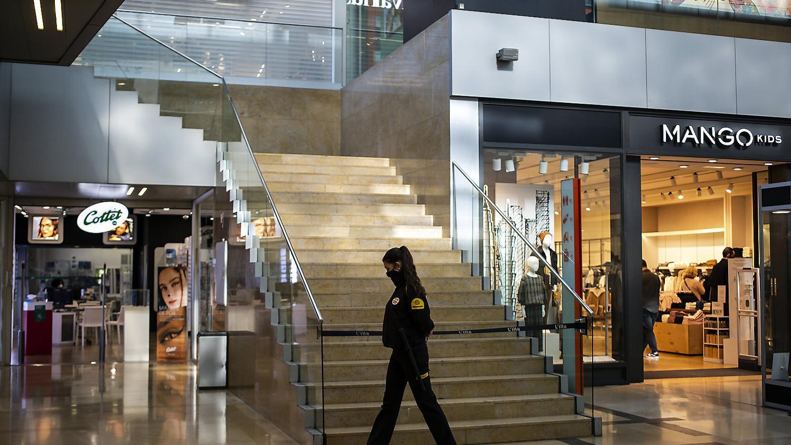 Image of a shopping mall with the premises facing the street open and the rest closed.