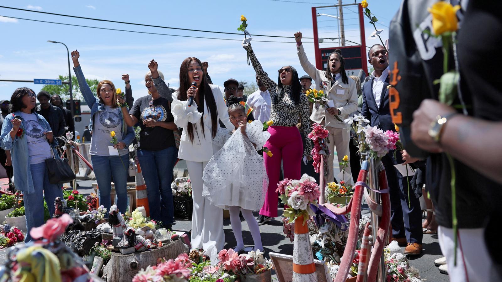 Family and community members pay tribute to George Floyd at the memorial erected in his memory at the site of his death.