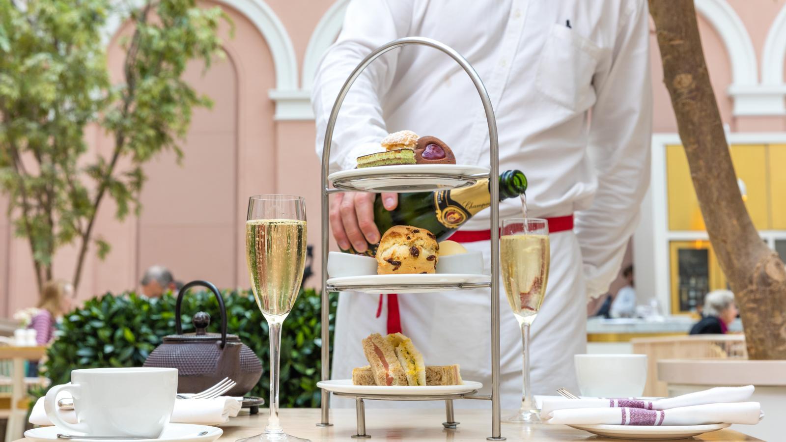 The Wallace afternoon tea, featuring praline profiteroles, raspberry and pistachio opera cake, and mini chocolate Turkish delight, served with champagne. A luxury in central London.