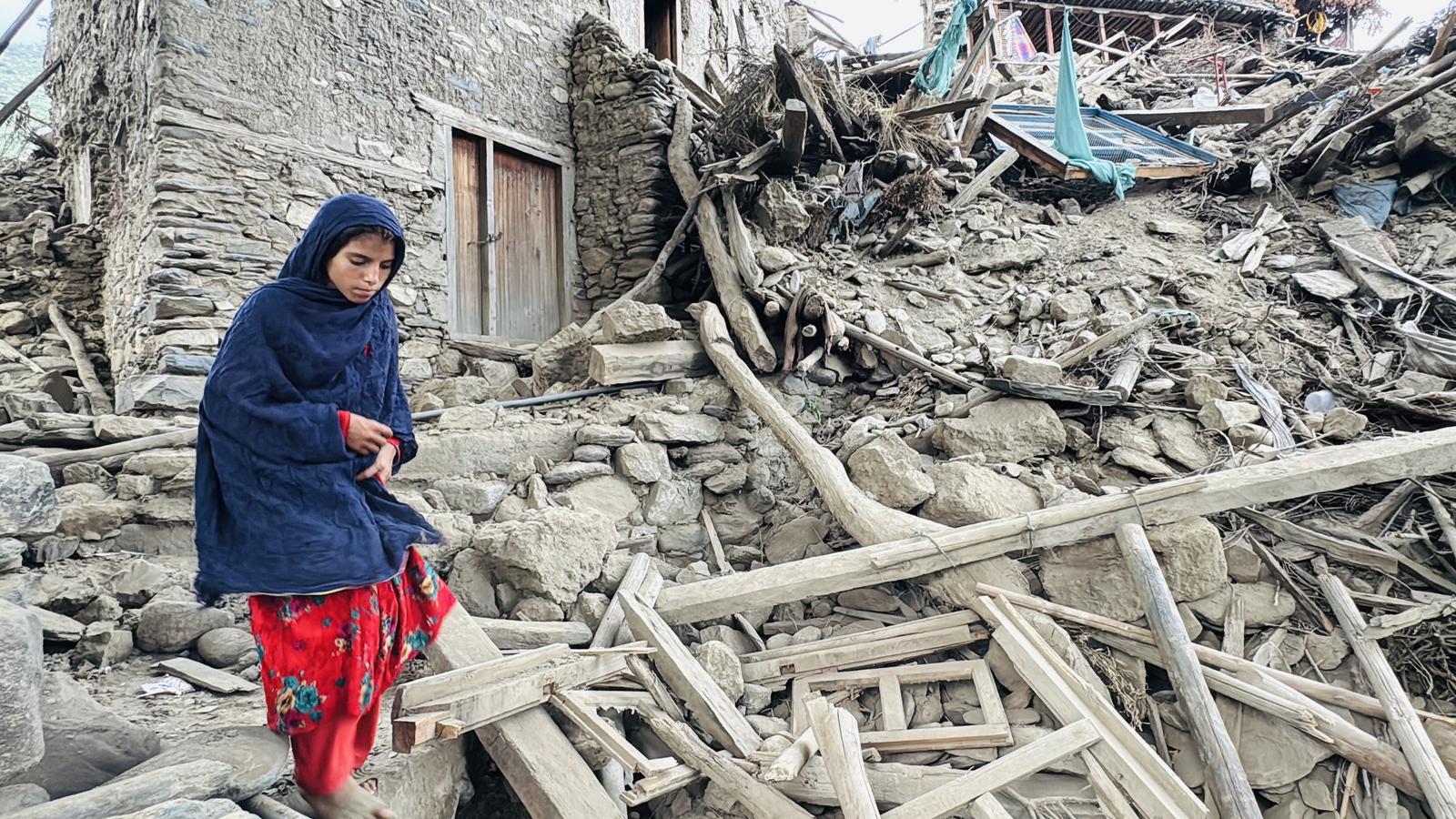 A girl stands next to the rubble caused by the earthquake in Kunar, Afghanistan.
