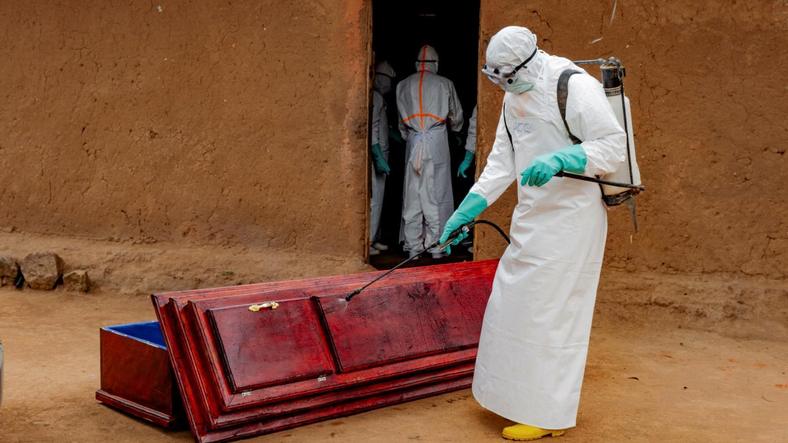 Civil protection members disinfect the coffin of a man dead from Ebola in Bunia, Ituri province, Democratic Republic of the Congo, on July 10, 2026.