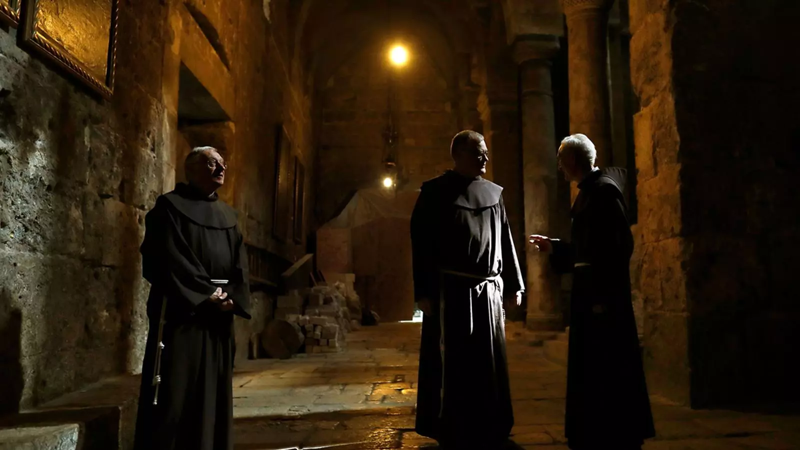 Frares franciscans conversen dins de la Basílica del Sant Sepulcre