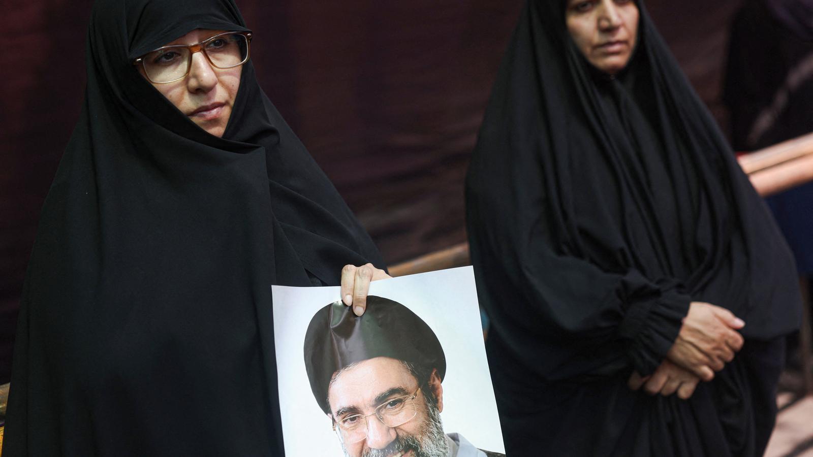 A woman with a photo of Iran's supreme leader, Mojtaba Khamenei, in Tehran, this week.