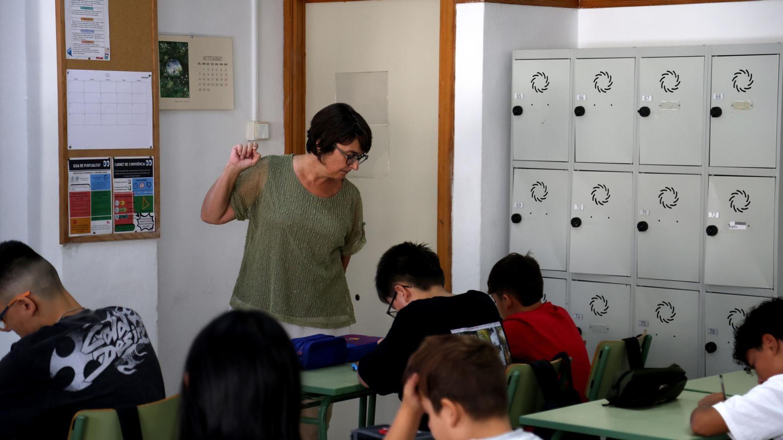 A teacher in the classroom with the students.