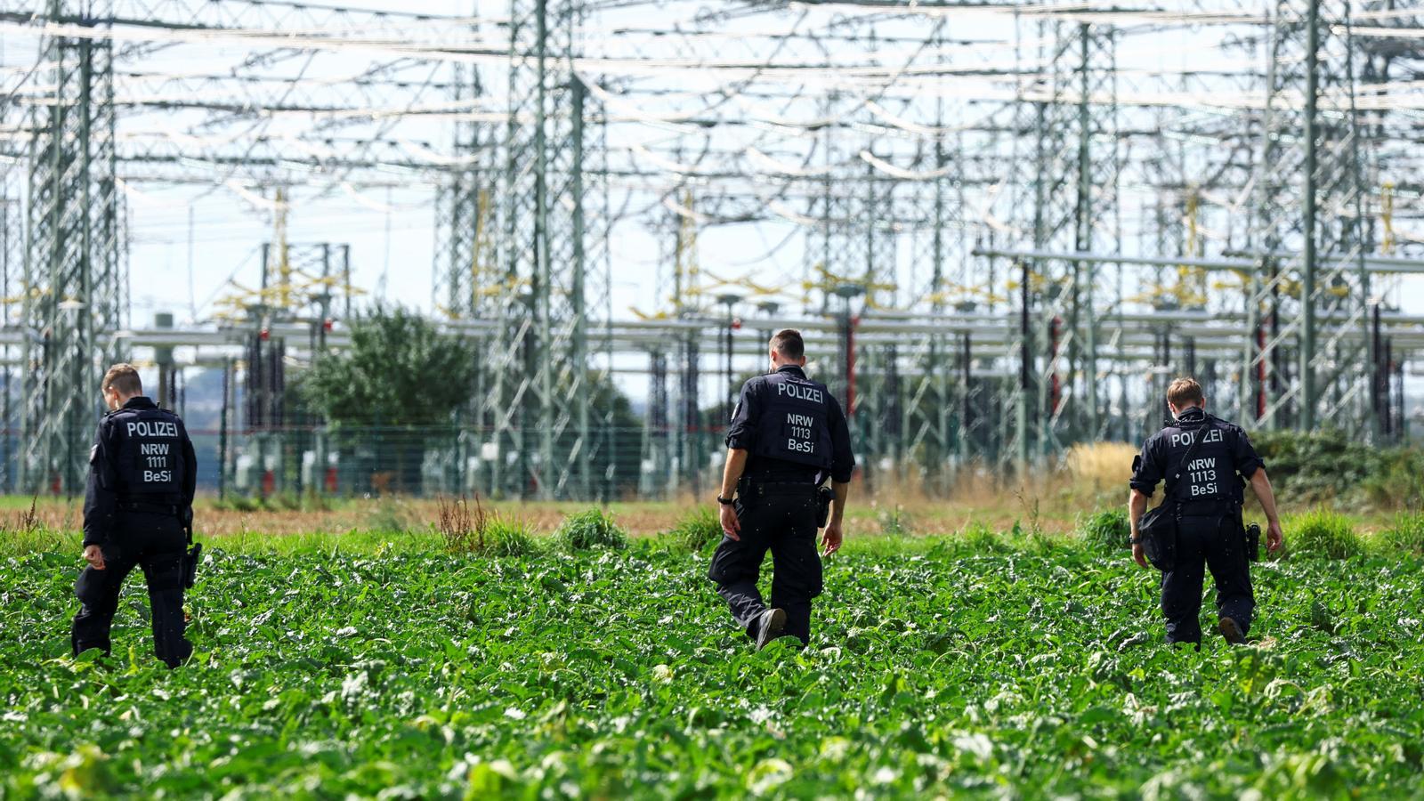 German police inspect a field in front of an electrical substation after this Wednesday's incidents, in Bergheim, Germany.