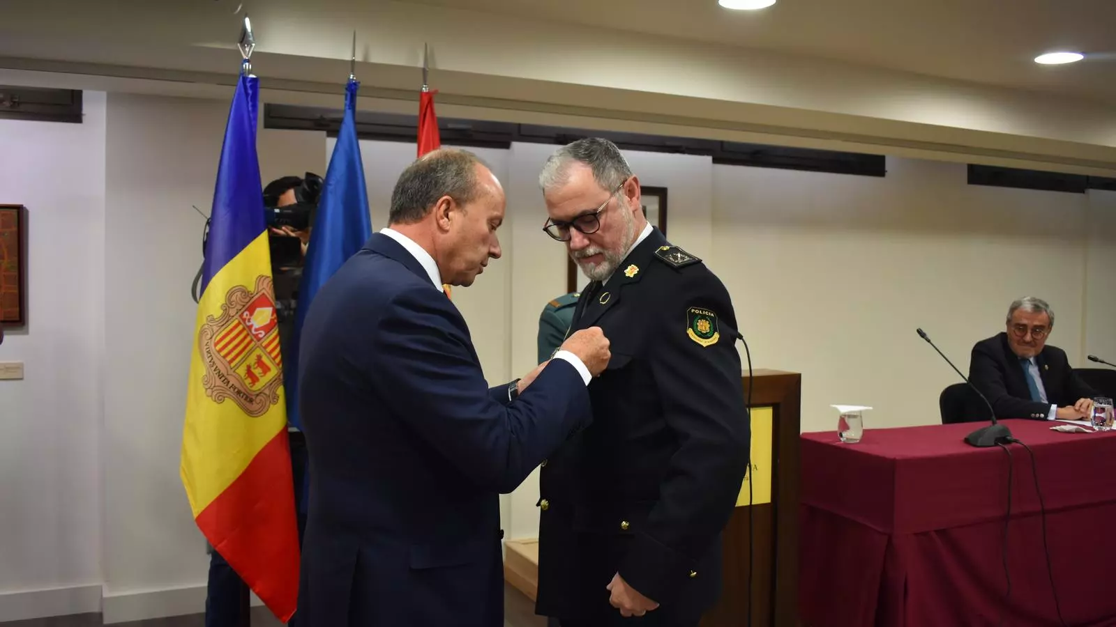 El ministre de Justícia i Interior, Josep Maria Rossell, entrega una de les medalles.