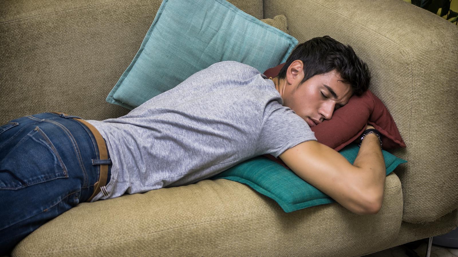 A boy taking a nap on the couch