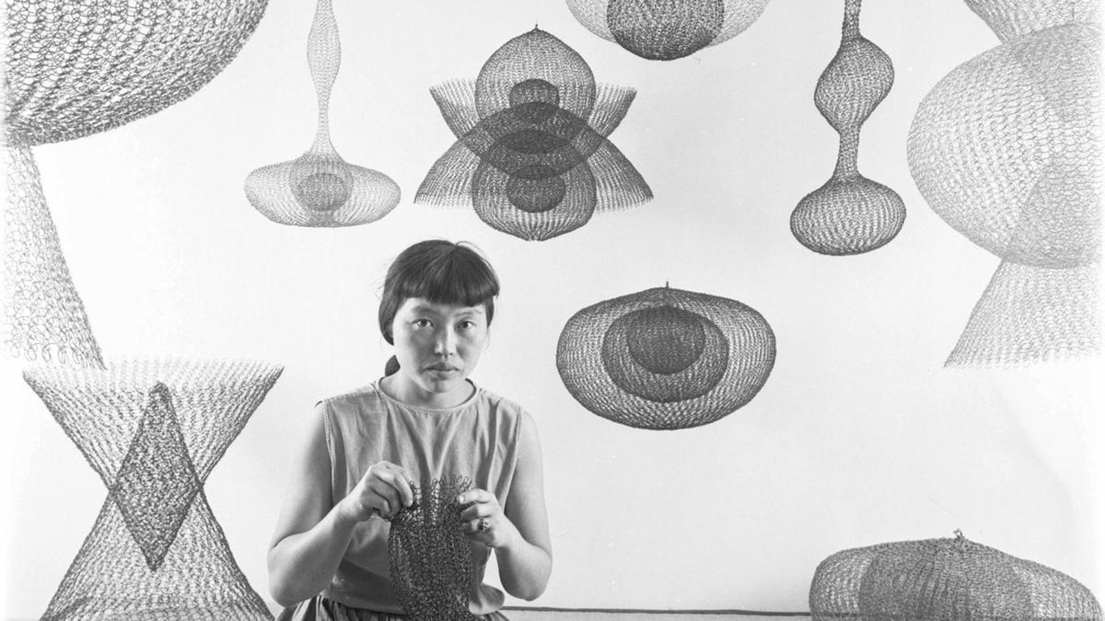 The artist Ruth Asawa making wire sculptures, California, USA, November 1954.