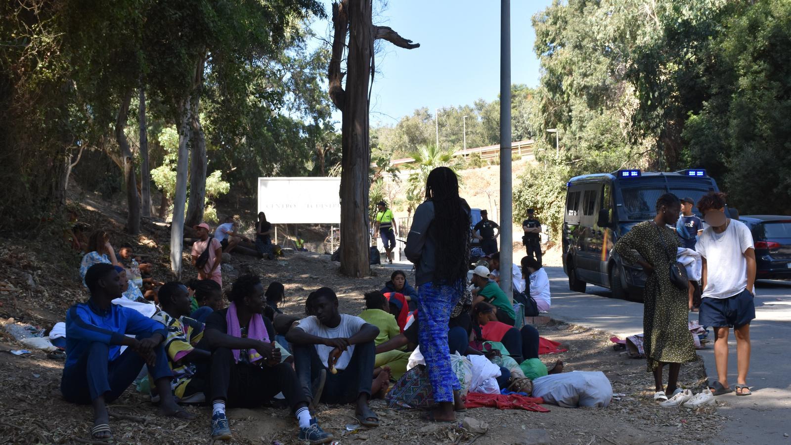 Different people waiting outside the CETI of Ceuta on August 6th.