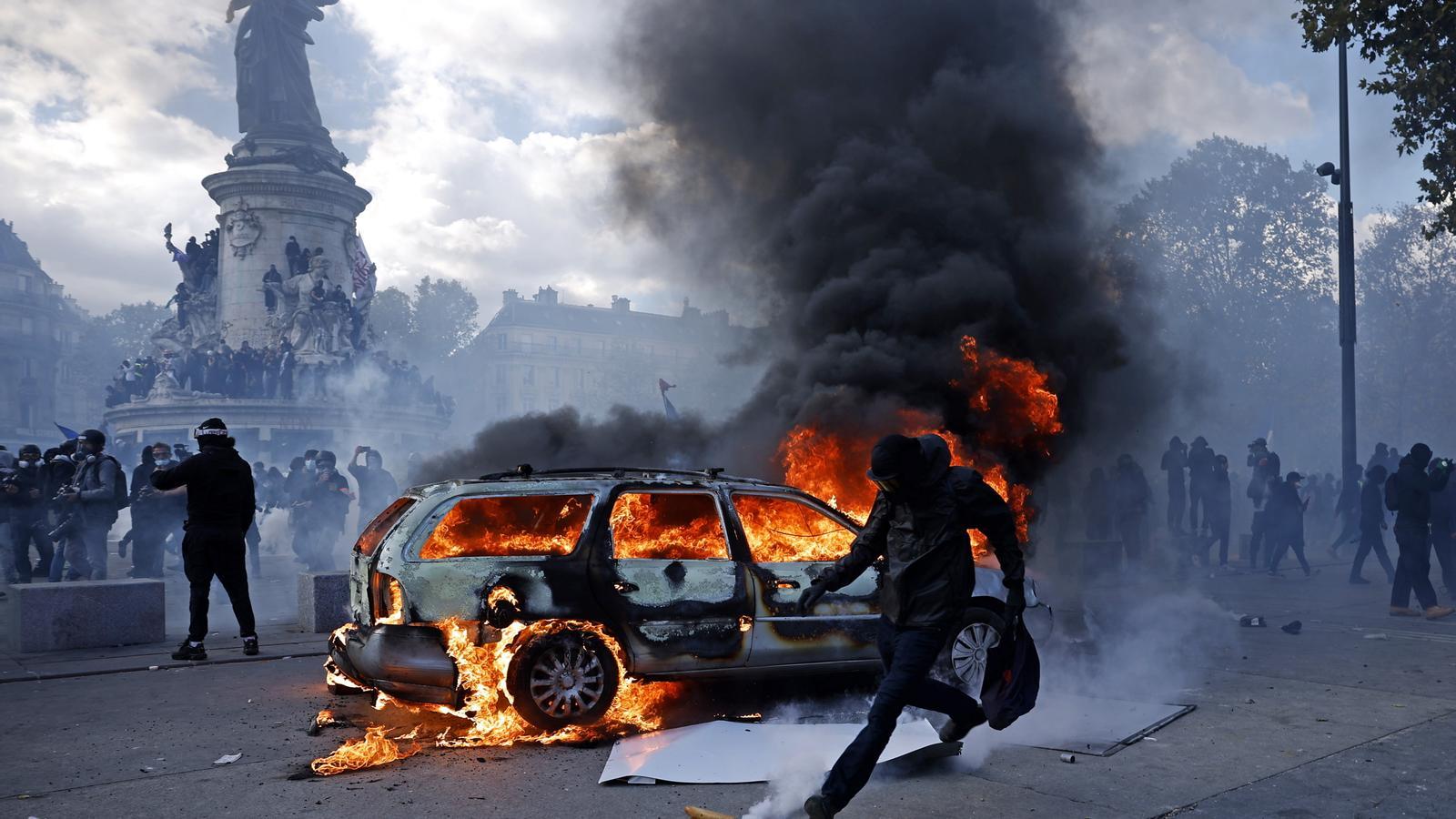 A car burning in the Place de la République during the protests in Paris.