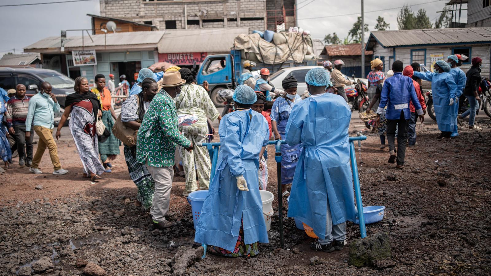 Healthcare workers with protective gowns and masks at a checkpoint in Kanyaruchinya, near Goma in the Democratic Republic of Congo.