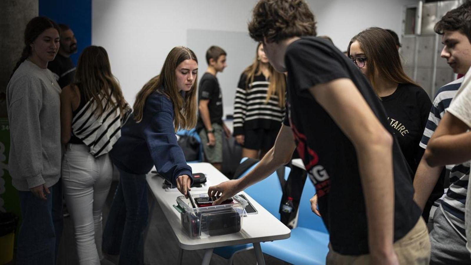 Fourth-year students at Zurich School leave their cell phones in a box while they teach.
