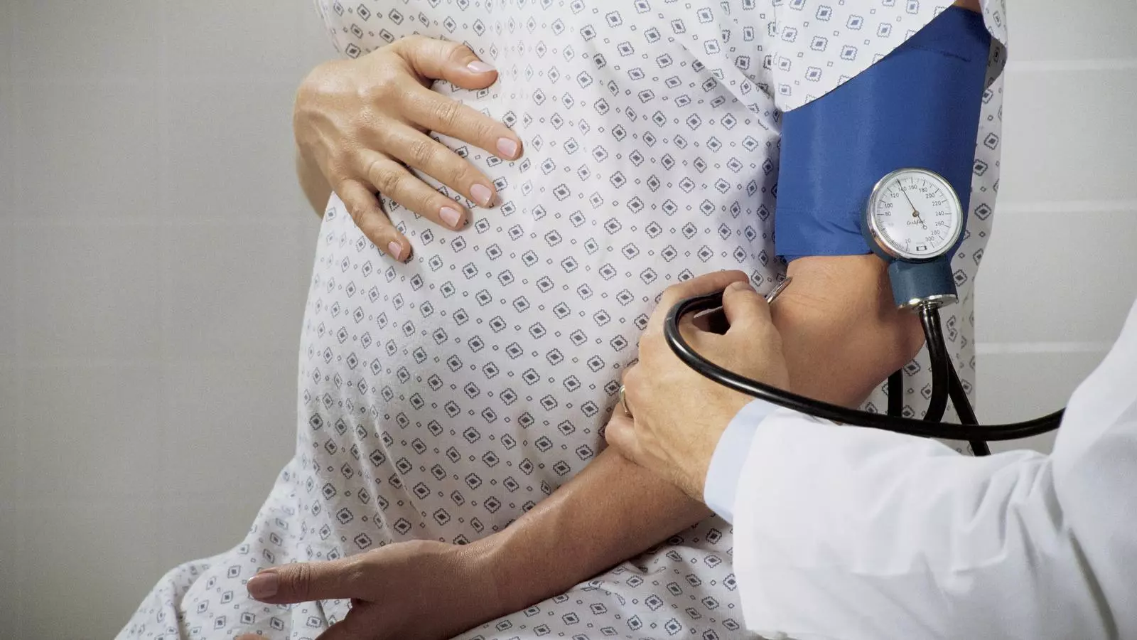 Una doctora pren la pressió arterial a una pacient en avançat estat de gestió