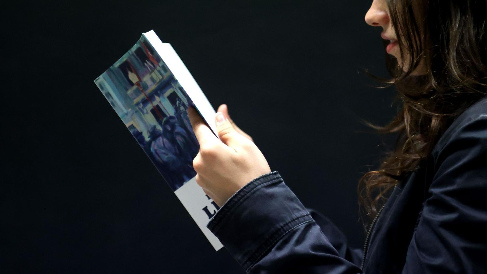 A teenager reads a book.