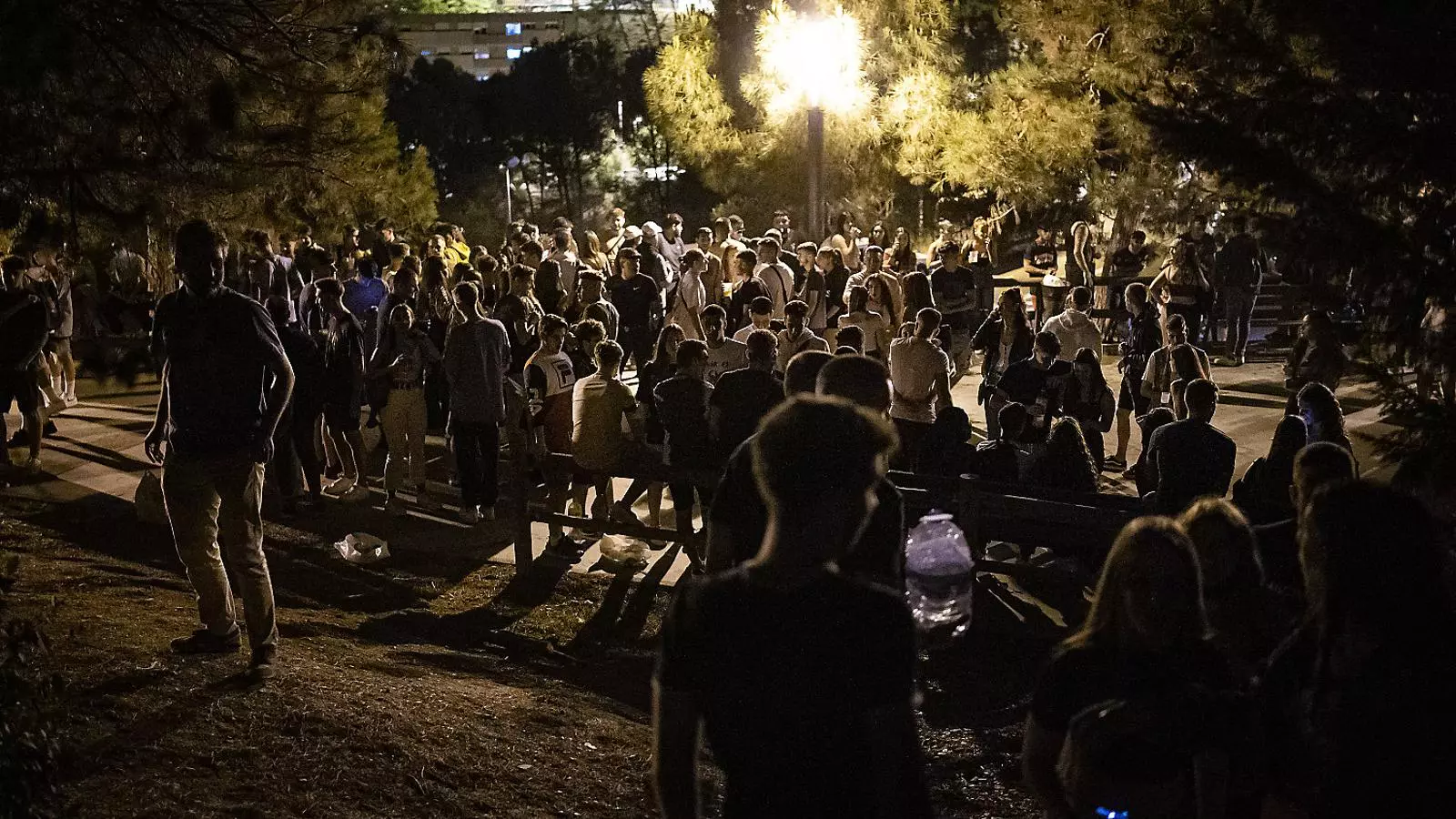 A group of young people participating in a Friday night botellón in Barcelona.