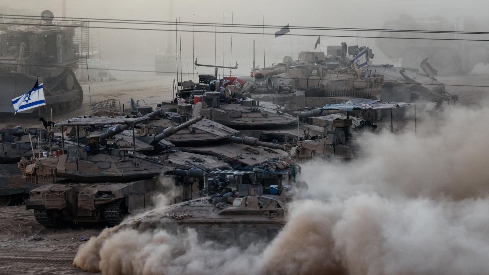 Israeli army tanks conduct maneuvers on the border between Israel and Gaza.